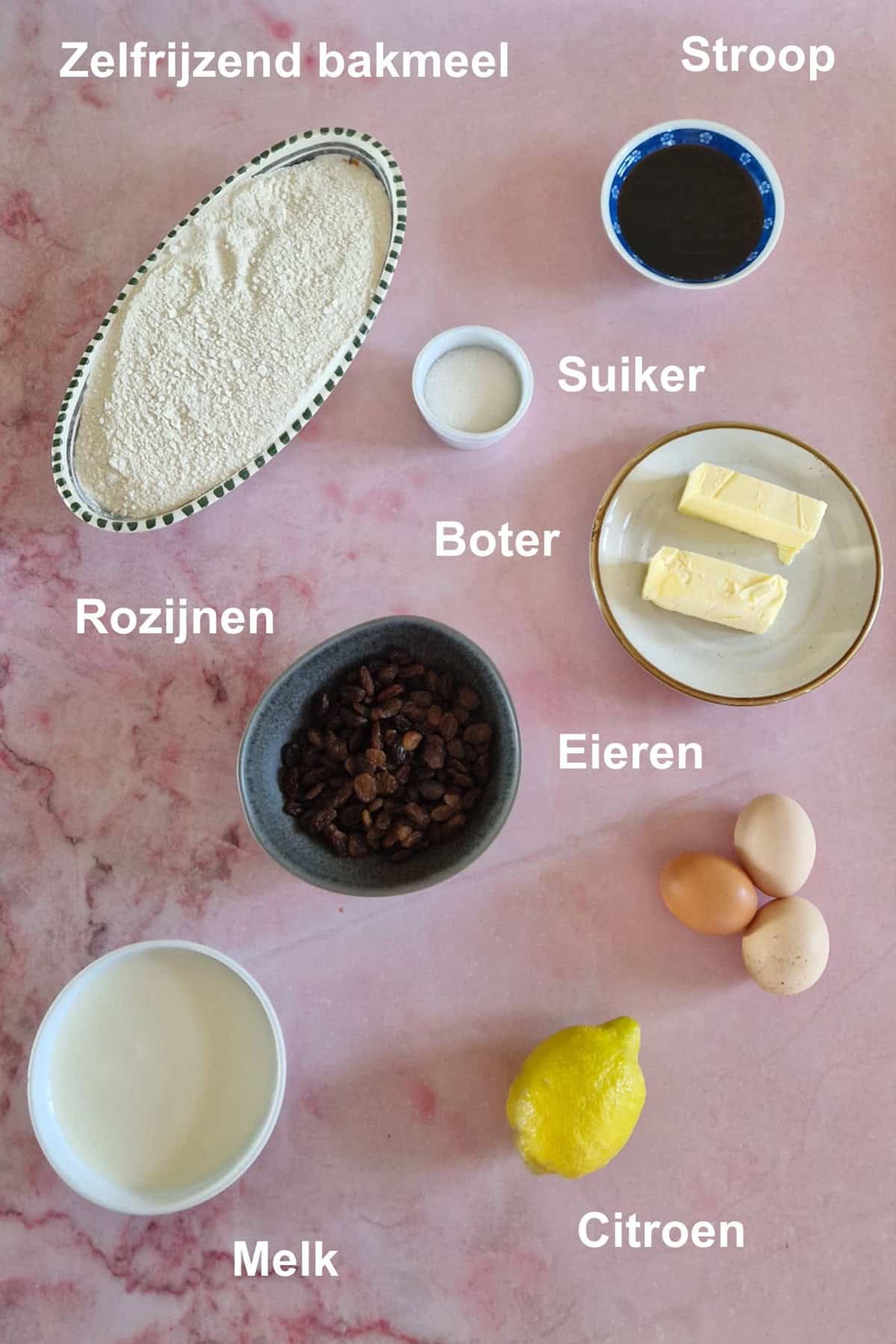 De ingrediënten om ouderwetse broeder te maken, uitgestald op een roze-marmeren ondergrond.